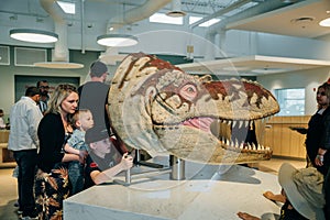 Drumheller, Canada - Mar 2023 Visitors flock to the dinosaur exhibits at the entrance of the Royal Tyrrell Museum