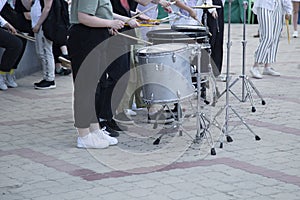 A drummer artist on a city street entertains people. Musicians on the street