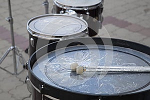 A drummer artist on a city street entertains people. Musicians on the street