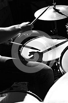 Drummer beats drums with drumsticks, close-up photo