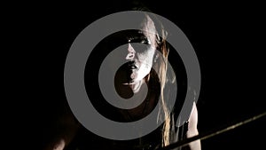 Drummer of black metal band. Close up dark background