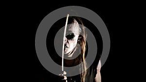Drummer of black metal band. Close up dark background. Slow motion