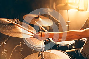 Drummer hands close up. play drums in music studio