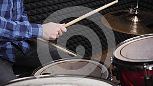 Drummer is hitting drum cymbals at sound recording studio, close up. Drum cymbal vibration. Drummer`s hand is playing drum kit. Mu