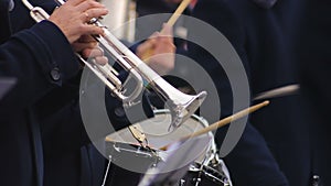 Drummer from orchestra actively playing drum setting music rhythm to band