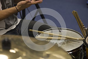 Drummer Placing Drum Sticks On Snare Drum