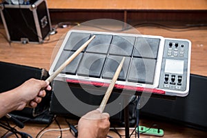 Drummer play electric drum digital drum music instrument.