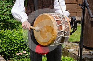 Drummer play folk music with drum and stick