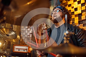 Drummer playing on drum kit, music performing