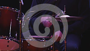 drummer playing drums. hitting a cymbal on a dark background, close-up. Drum cymbal vibration. slow motion video.