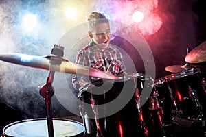 Drummer playing the drums with smoke