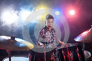 Drummer playing the drums with smoke