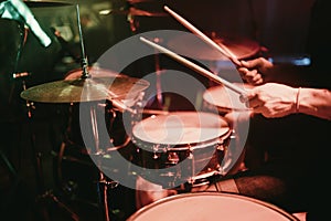 Drummer playing his drum kit on concert in club photo