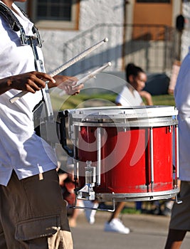 Drummer Playing Red Snare Drums in Parade