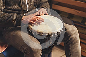 The drummer plays the ethnic percussion musical instrument djembe