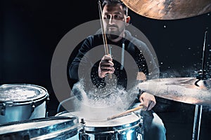 Drummer rehearsing on drums before rock concert. Man recording music on drum set in studio