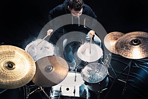 Drummer rehearsing on drums before rock concert. Man recording music on drum set in studio