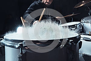 Drummer rehearsing on drums before rock concert. Man recording music on drum set in studio