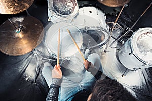 Drummer rehearsing on drums before rock concert. Man recording music on drum set in studio