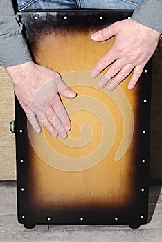 Drummer`s hands while playing the cajon drum