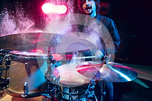 Drummer's rehearsing on drums before rock concert. Man recording music on drumset in studio