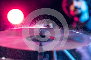 Drummer's rehearsing on drums before rock concert. Man recording music on drumset in studio