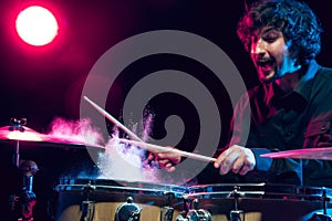 Drummer's rehearsing on drums before rock concert. Man recording music on drumset in studio