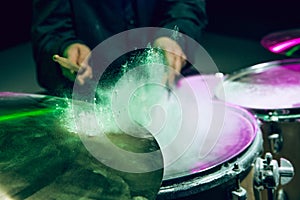 Drummer's rehearsing on drums before rock concert. Man recording music on drumset in studio