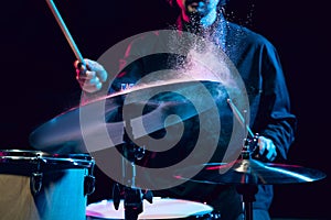 Drummer's rehearsing on drums before rock concert. Man recording music on drumset in studio