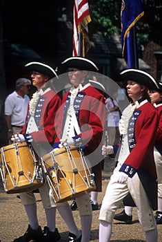 Drummers in red and white colonial uniforms