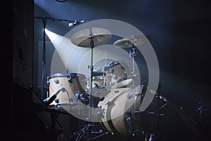 Drumset on a stage with one lightsource