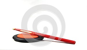 Drumsticks and drum practice pad isolated on white background