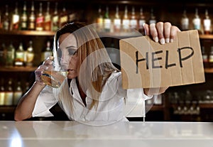 Drunk alcoholic blond woman drinking alcohol asking for help in bar or pub