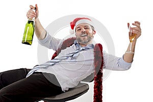 Drunk businessman drinking champagne wearing santa