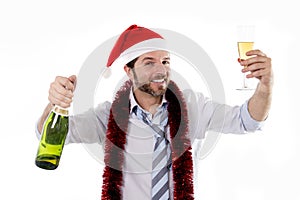 Drunk businessman drinking champagne wearing santa hat isolated white background