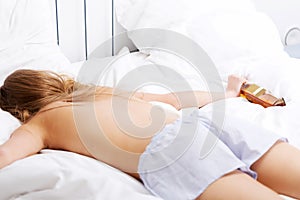 Drunk caucasian woman lying in bed