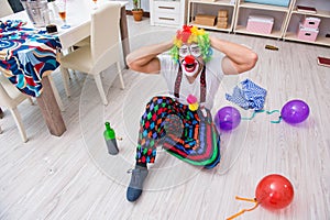 The drunk clown celebrating having a party at home