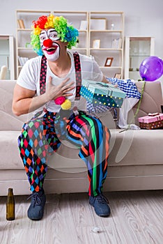 The drunk clown celebrating having a party at home