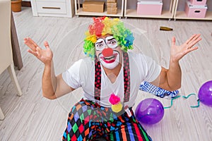 The drunk clown celebrating having a party at home