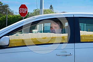 Drunk driver man in car filled with beer showing you can`t hide driving while intoxicated photo