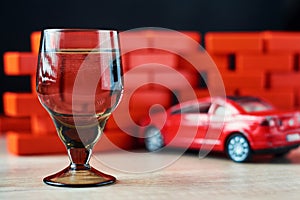 Drunk driving car crash accident. Don`t drive after drink concept. Shot glass and a broken car