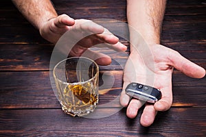 Drunk driving. Glass in man hands and car keys. Drink.