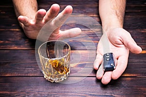 Drunk driving. Glass in man hands and car keys. Drink.