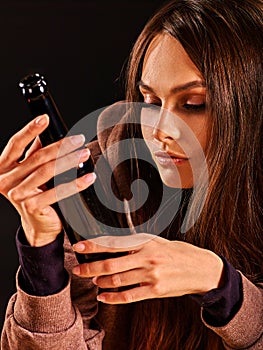 Drunk girl holding bottle of vodka.