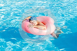 A drunk guy swims on inflatable circle in the pool. travel of a Russian tourist photo