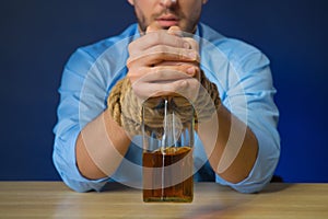 Drunk man drinking alcohol at the table