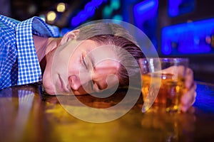 Drunk man lying on bar counter