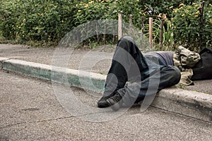 Drunk man lying on pavement.