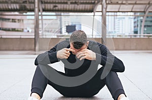 Drunk man sitting on street after drinking alcohol in party at night