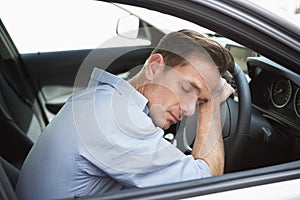 Drunk man slumped on steering wheel photo